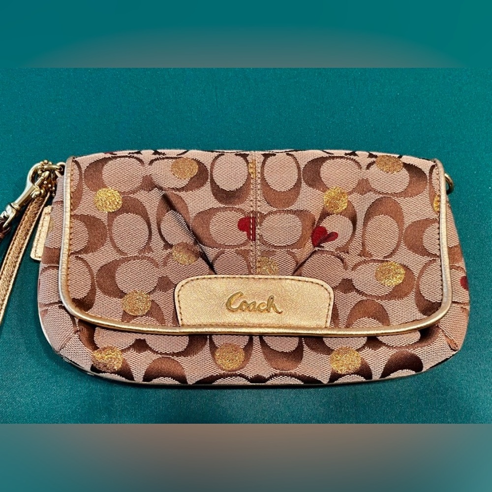 Coach Wristlet. Poppy Hearts design. Gold. New. Snap closure. Spotless interior.